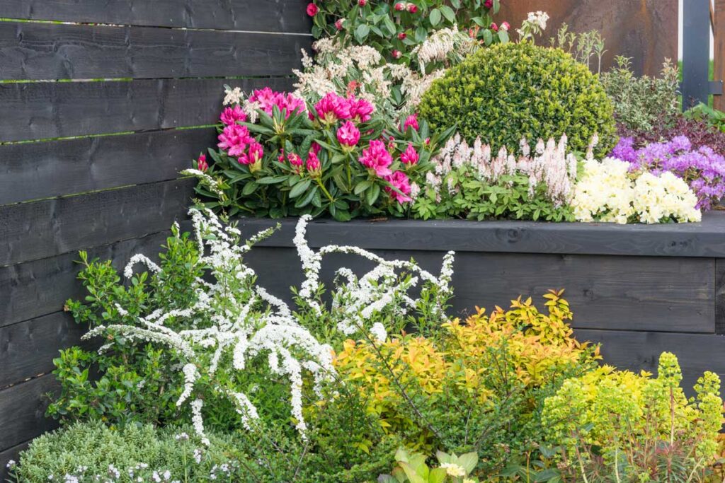 landscaping design tips | layered garden design with colorful plants and textures