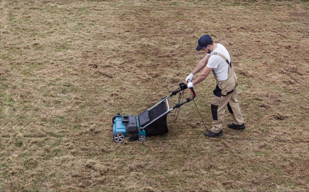lawn aeration North Port FL | Landscaping professional performing core aeration on a Florida lawn