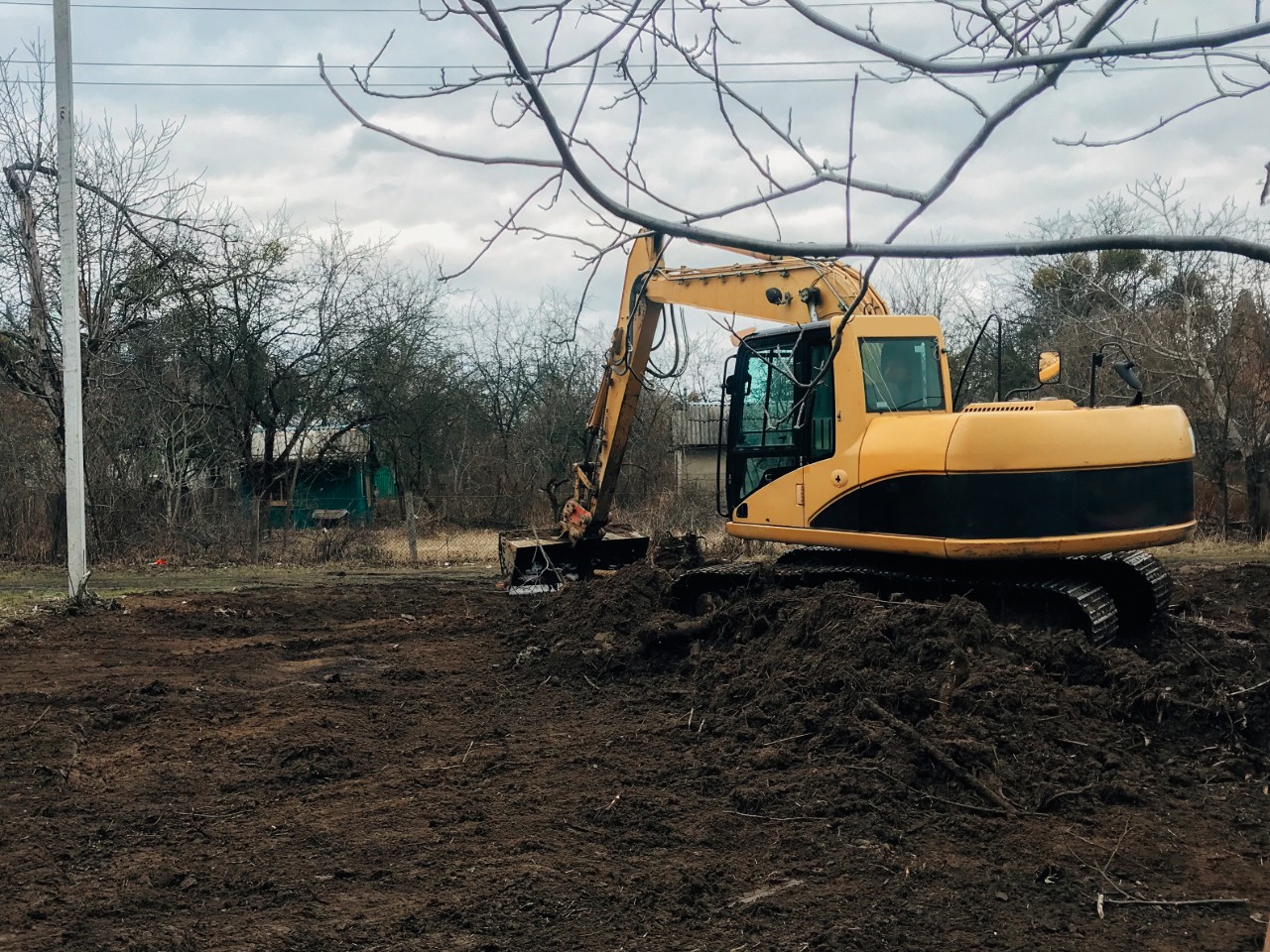 Lot clearing vs house pad grading North Port residential construction site showing cleared land and prepared soil